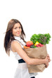woman holding a shopping bag full of groceries