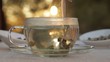 Woman mixes glass of tea outdoors