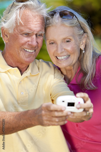 Photo: Happy Senior Couple Taking Self Portrait Photograph with Digital Happy Senior Couple Taking Self Portrait Photograph with Digital