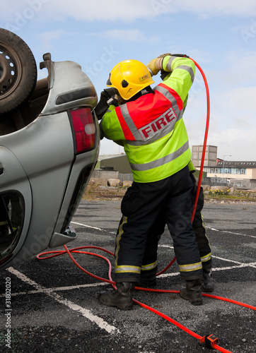 Photo: Fireman with Power Wedge at car crash resque Fireman with Power Wedge at car crash resque