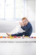 Happy little boy playing on floor