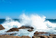 Waves crashing onto coastal rocks