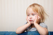 a sick girl is sitting near the bed