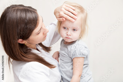 Photo: mother is holding a sick daughte mother is holding a sick daughte