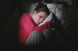 Scared Teenage Girl Sitting In Bedroom