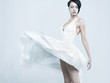 Beautiful young lady in a billowing white dress