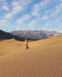 A photographer photographing sand waves