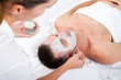 Foto: beautician applying facial mask on middle aged man beautician applying facial mask on middle aged man
