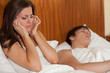Unhappy woman and her snoring husband.