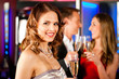 Three friends with champagner in a bar