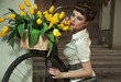 Beauty brunette with bunch of flowers