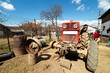 Photo: Beaten up old tractor in the countryside, on a jack Beaten up old tractor in the countryside, on a jack