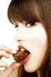 sexy woman eating a bar of chocolate - studio shot