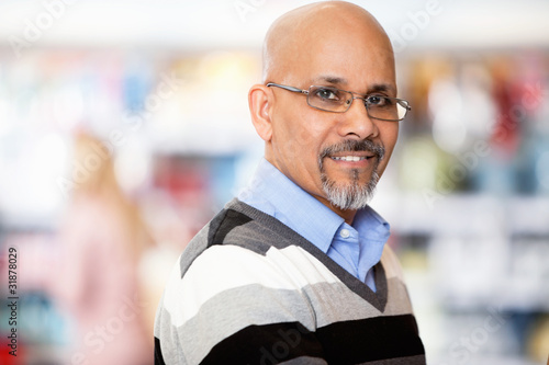 Photo: Mature man smiling while shopping Mature man smiling while shopping