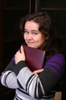Pretty brunette girl with book.