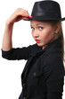 Beautiful young woman holds her hat bolder.