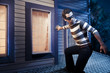Photo: Thief walking on the roof of a house at night Thief walking on the roof of a house at night