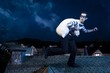Thief on the roof running away at night