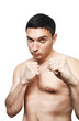 young man with naked torso in boxing position on white