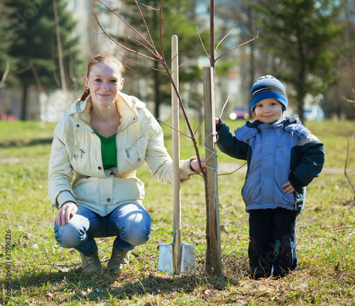 Photo: mother and son planting tree mother and son planting tree