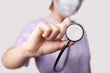Photo: doctor holding stethoscope pointed toward camera doctor holding stethoscope pointed toward camera