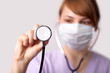 Photo: Female doctor holding stethoscope pointed toward camera Female doctor holding stethoscope pointed toward camera