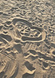 heart on the beach sand, footprints