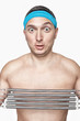 Funny guy with blue sweatband pulling coil springs expander