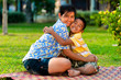 Foto: Mother and son play in a park Mother and son play in a park