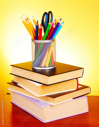 Photo: Stationery and books on red background Stationery and books on red background
