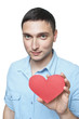 Young man in shirt holding red heart shape isolated on white