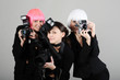three girls with cameras
