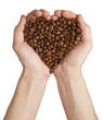 Heart shape made from coffee beans in hands Heart shape made from coffee beans in hands