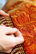 Craftsman hands working on a curtain