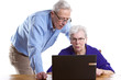 Foto: Elderly man and woman behind laptop Elderly man and woman behind laptop