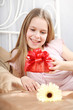 beautiful ten years' girl has seen in bed a gift on birthday.