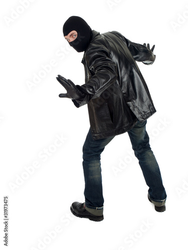 Photo: young male thief in balaclava and black leather jacket young male thief in balaclava and black leather jacket