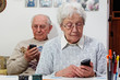 senior couple with smartphones