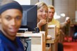 Young Adults In A Library Using Computer Terminals