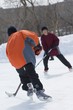 Boys Playing Ice Hockey On An Outdoor Rink