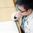 Handsome man sitting and reading in library