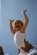 Cheerful little girl in her dad's arms