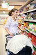 Photo: Mother with Carriage in Supermarket Mother with Carriage in Supermarket