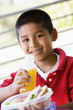Boy eating lunch at kindergarten