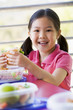 Girl eating lunch at kindergarten