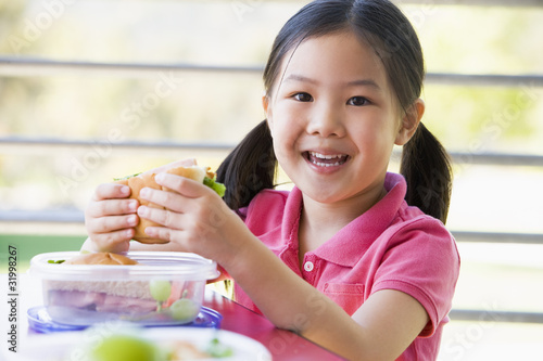 Photo: Girl eating lunch at kindergarten Girl eating lunch at kindergarten