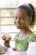 Girl eating lunch at kindergarten