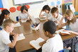 Schoolchildren reading books in class