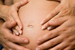 hands holding pregnant tummy