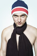 Young man in red striped hat and black scarf with naked torso